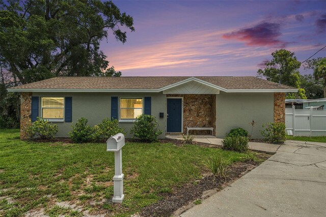 6601 N Elizabeth St, Tampa, FL 33604 - ranch-style house with stone siding, stucco siding, and a shingled roof