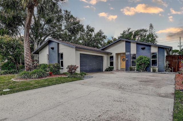 10900 65th Way N, Pinellas Park, FL 33782 - mid-century home with stucco siding, concrete driveway, and a garage