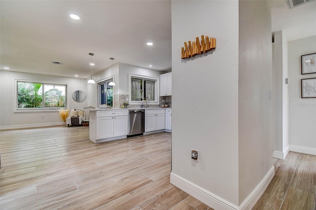 10900 65th Way N, Pinellas Park, FL 33782 - kitchen featuring stainless steel dishwasher, white cabinets, light countertops, light wood finished floors, and recessed lighting