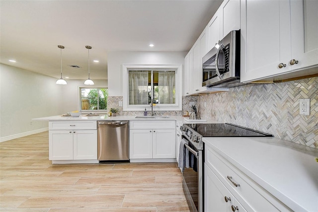 10900 65th Way N, Pinellas Park, FL 33782 - kitchen featuring stainless steel appliances, backsplash, light countertops, recessed lighting, and white cabinetry