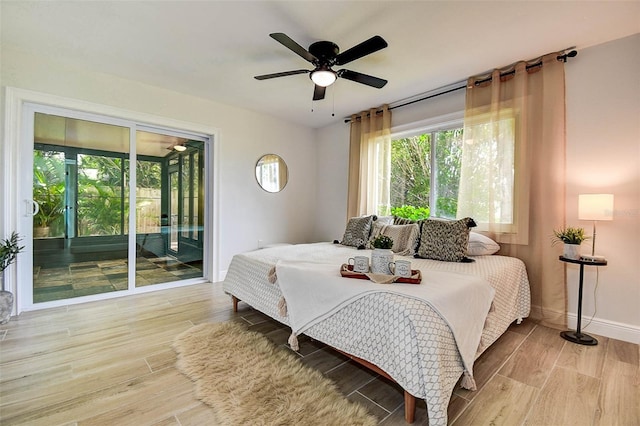 10900 65th Way N, Pinellas Park, FL 33782 - bedroom featuring access to outside, wood finished floors, and a ceiling fan