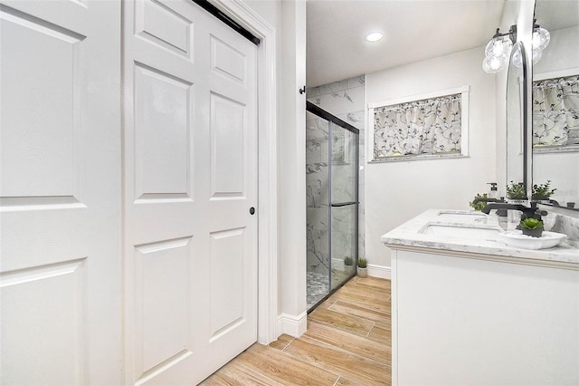 10900 65th Way N, Pinellas Park, FL 33782 - full bath with a marble finish shower, double vanity, wood finished floors, and recessed lighting