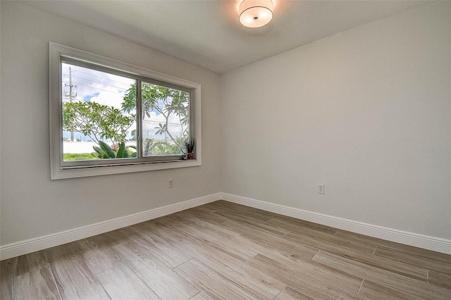 10900 65th Way N, Pinellas Park, FL 33782 - unfurnished room featuring baseboards and wood finished floors