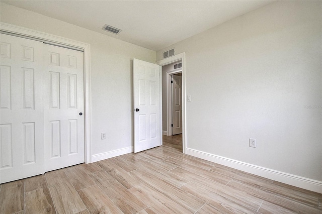 10900 65th Way N, Pinellas Park, FL 33782 - unfurnished bedroom with light wood-style flooring and a closet