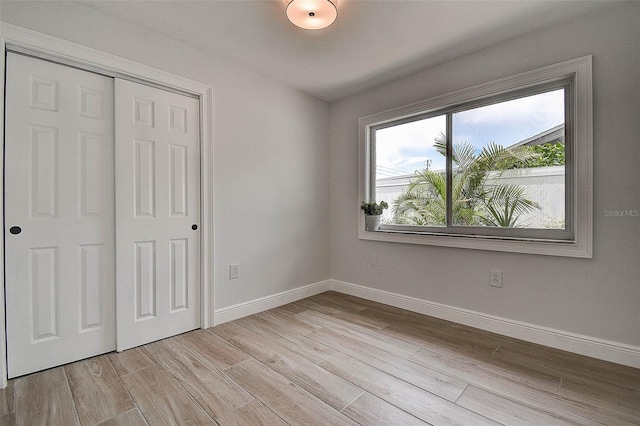 10900 65th Way N, Pinellas Park, FL 33782 - unfurnished bedroom with a closet and light wood-style floors