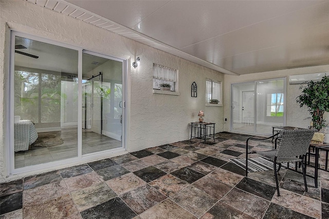 10900 65th Way N, Pinellas Park, FL 33782 - foyer entrance featuring a textured wall, stone tile floors, and a wall mounted AC