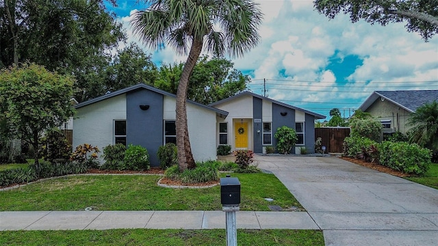 10900 65th Way N, Pinellas Park, FL 33782 - mid-century home featuring stucco siding and concrete driveway