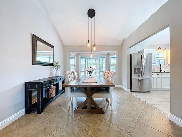 1437 Stonehenge Way, Palm Harbor, FL 34683 - dining space featuring lofted ceiling, healthy amount of natural light, and light tile patterned floors