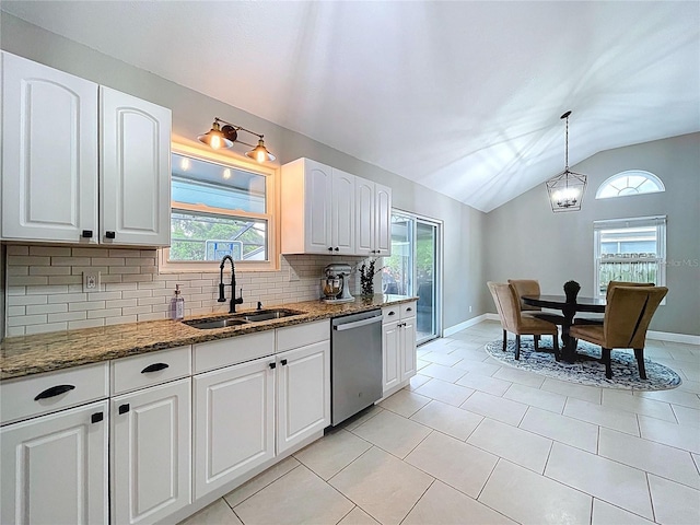 1437 Stonehenge Way, Palm Harbor, FL 34683 - kitchen featuring stainless steel dishwasher, lofted ceiling, dark stone counters, tasteful backsplash, and plenty of natural light
