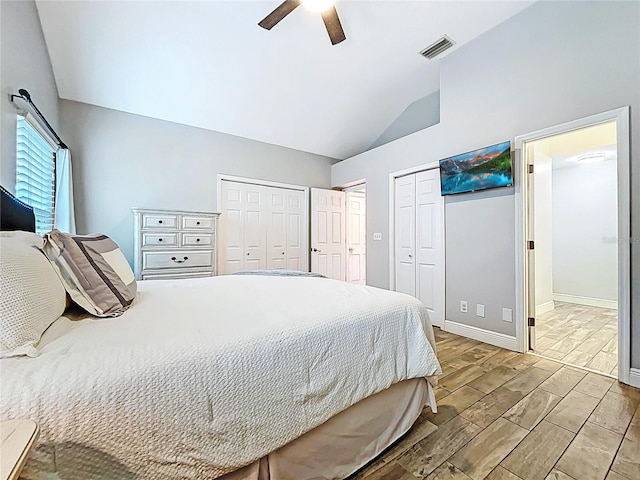 1437 Stonehenge Way, Palm Harbor, FL 34683 - bedroom with lofted ceiling, multiple closets, wood tiled floors, and a ceiling fan