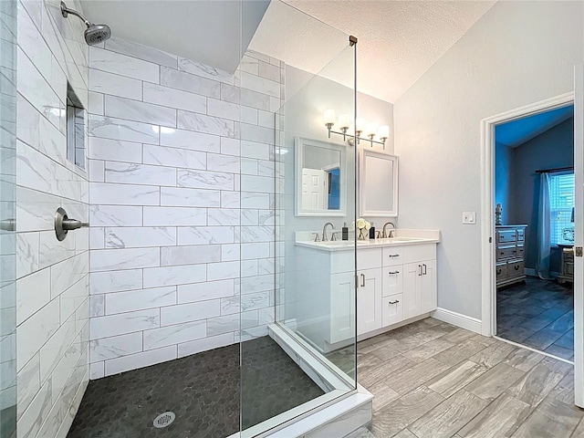 1437 Stonehenge Way, Palm Harbor, FL 34683 - bathroom with lofted ceiling, walk in shower, double vanity, a chandelier, and a textured ceiling