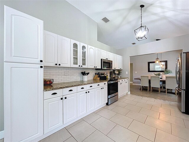1437 Stonehenge Way, Palm Harbor, FL 34683 - kitchen featuring appliances with stainless steel finishes, tasteful backsplash, dark stone countertops, glass insert cabinets, and white cabinets