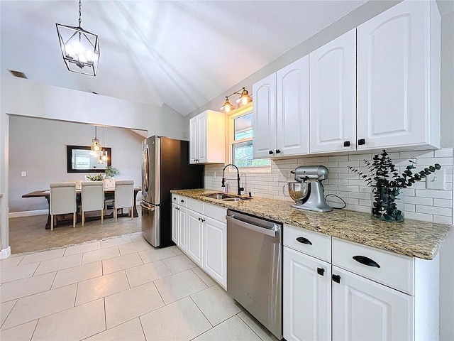 1437 Stonehenge Way, Palm Harbor, FL 34683 - kitchen featuring stainless steel appliances, backsplash, lofted ceiling, white cabinetry, and light stone counters