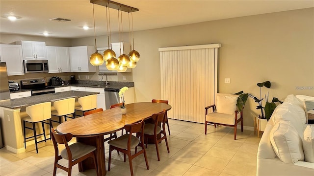 31363 Sun Kettle Loop, Wesley Chapel, FL 33545 - dining area with light tile patterned floors and recessed lighting