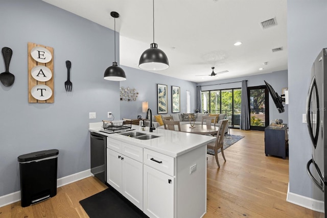 4311 W Fig St Unit 1, Tampa, FL 33609 - kitchen with a peninsula, dishwashing machine, open floor plan, white cabinets, and light countertops
