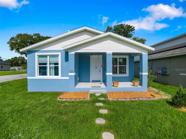 239 Burbank Ave, Lakeland, FL 33801 - view of front of property with a porch, a front lawn, and stucco siding