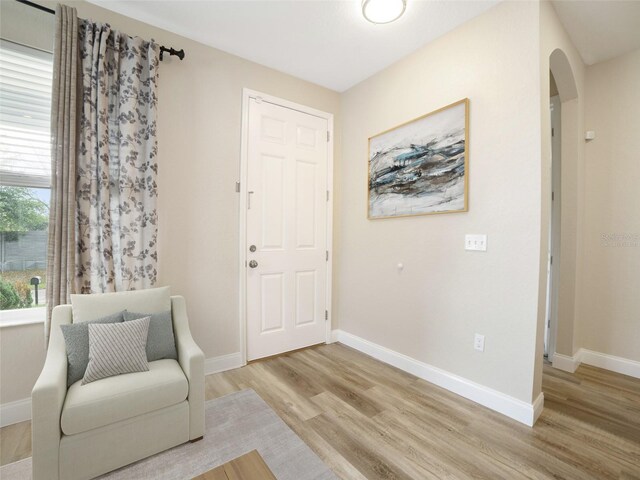 239 Burbank Ave, Lakeland, FL 33801 - living area with arched walkways and light wood-type flooring