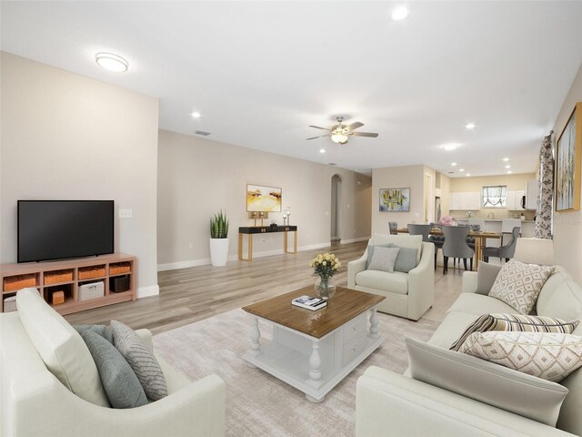 239 Burbank Ave, Lakeland, FL 33801 - living area featuring recessed lighting, arched walkways, light wood-type flooring, and ceiling fan