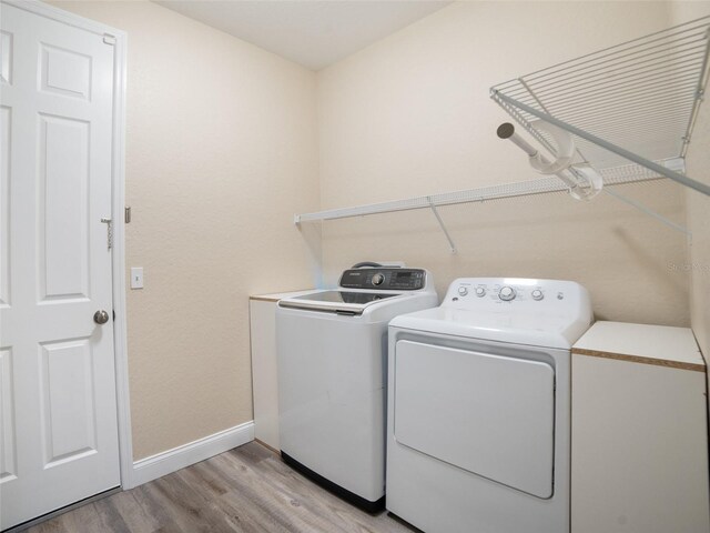239 Burbank Ave, Lakeland, FL 33801 - washroom with washer and dryer and light wood-type flooring