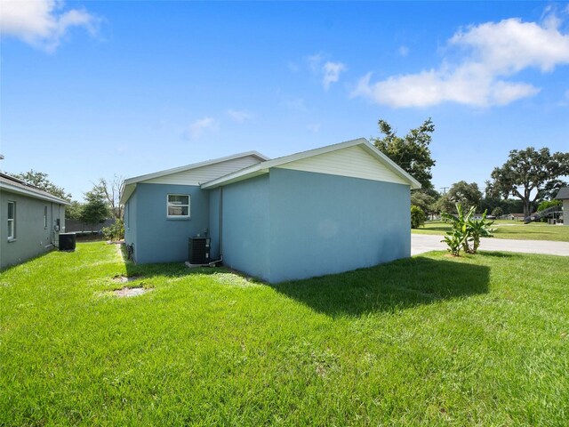239 Burbank Ave, Lakeland, FL 33801 - view of home's exterior with a lawn and stucco siding