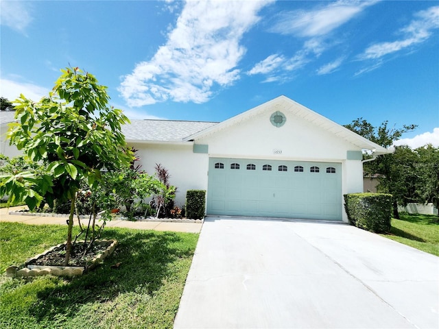 11653 Orleans Ln, Port Richey, FL 34668 - ranch-style home featuring stucco siding, a garage, and driveway