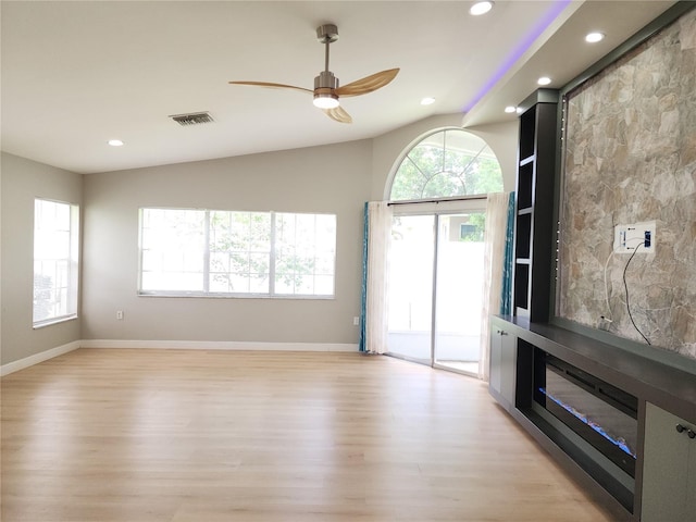 11653 Orleans Ln, Port Richey, FL 34668 - unfurnished living room featuring healthy amount of natural light, light wood-style flooring, a ceiling fan, and recessed lighting