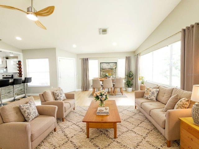11653 Orleans Ln, Port Richey, FL 34668 - living area featuring vaulted ceiling, healthy amount of natural light, recessed lighting, a ceiling fan, and light wood-type flooring