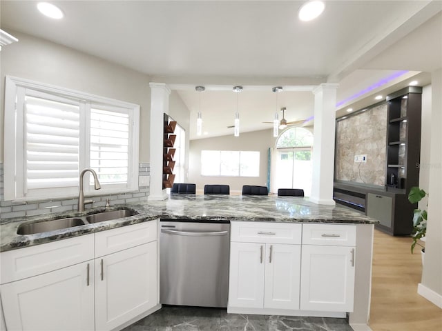 11653 Orleans Ln, Port Richey, FL 34668 - kitchen with dishwasher, a peninsula, white cabinetry, stone countertops, and vaulted ceiling