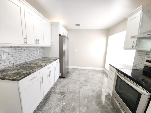 11653 Orleans Ln, Port Richey, FL 34668 - kitchen featuring stainless steel appliances, wall chimney range hood, decorative backsplash, and white cabinetry