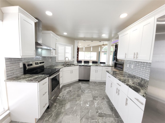 11653 Orleans Ln, Port Richey, FL 34668 - kitchen with appliances with stainless steel finishes, wall chimney range hood, plenty of natural light, recessed lighting, and decorative backsplash
