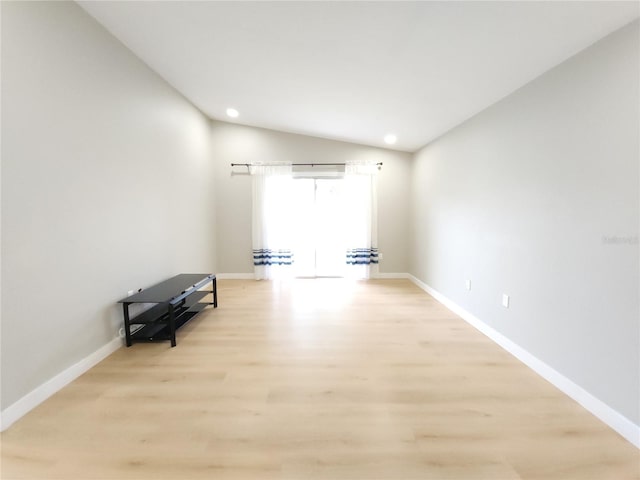 11653 Orleans Ln, Port Richey, FL 34668 - unfurnished room with lofted ceiling, light wood-style floors, and recessed lighting