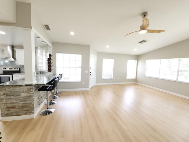 11653 Orleans Ln, Port Richey, FL 34668 - living room featuring plenty of natural light, light wood finished floors, ceiling fan, and recessed lighting