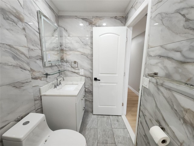 11653 Orleans Ln, Port Richey, FL 34668 - half bath featuring vanity, tile walls, and wood finished floors