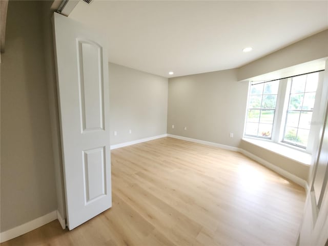 11653 Orleans Ln, Port Richey, FL 34668 - empty room with light wood-type flooring and recessed lighting