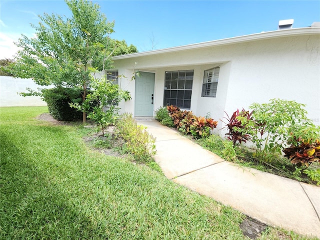 11653 Orleans Ln, Port Richey, FL 34668 - entrance to property with stucco siding and a lawn