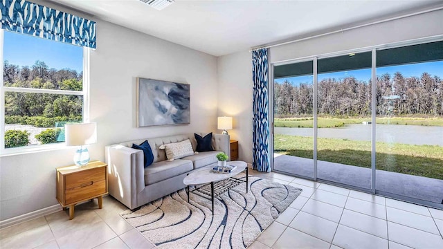8110 Swan Mist Way, Wesley Chapel, FL 33545 - living area featuring tile patterned flooring and view of wooded area