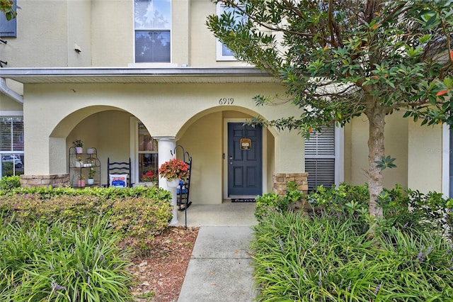 6919 Hawthorne Trace Ln, Riverview, FL 33578 - property entrance featuring stucco siding and a porch
