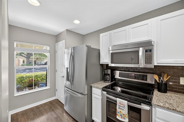 6919 Hawthorne Trace Ln, Riverview, FL 33578 - kitchen featuring appliances with stainless steel finishes, white cabinets, decorative backsplash, wood finished floors, and light stone countertops