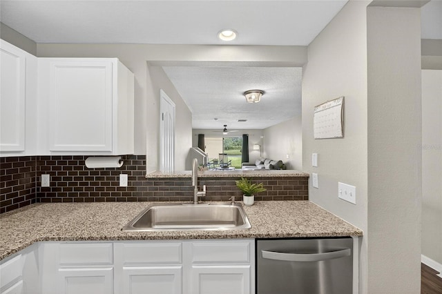6919 Hawthorne Trace Ln, Riverview, FL 33578 - kitchen with stainless steel dishwasher, white cabinetry, tasteful backsplash, and light stone countertops