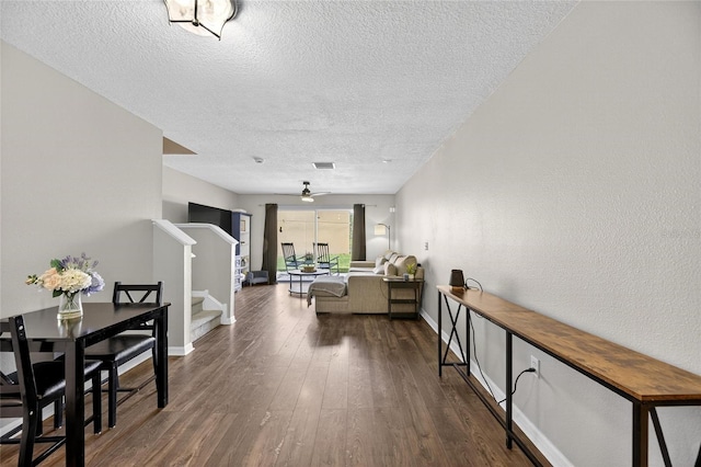 6919 Hawthorne Trace Ln, Riverview, FL 33578 - hallway featuring stairs, a textured ceiling, and wood finished floors