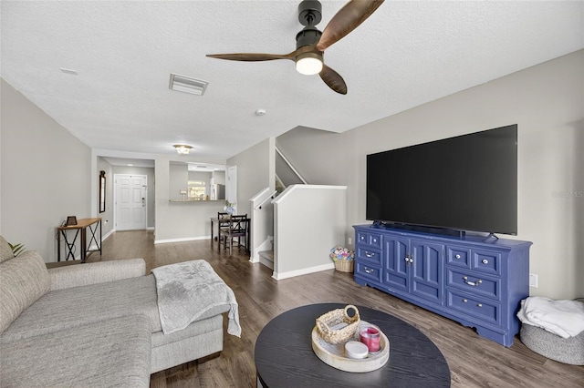 6919 Hawthorne Trace Ln, Riverview, FL 33578 - living area featuring ceiling fan, dark wood-type flooring, stairs, and a textured ceiling