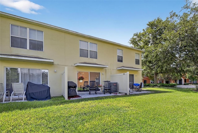 6919 Hawthorne Trace Ln, Riverview, FL 33578 - back of property with a patio area, a lawn, and stucco siding
