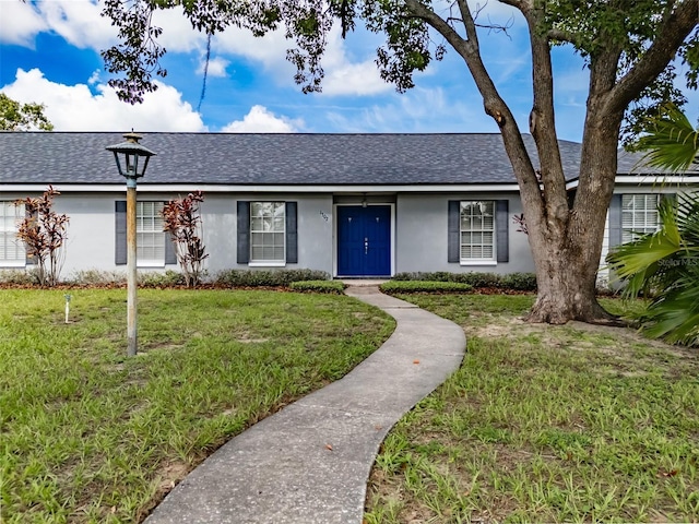 1302 Ivywood Dr, Brandon, FL 33510 - ranch-style house featuring roof with shingles, stucco siding, and a front yard