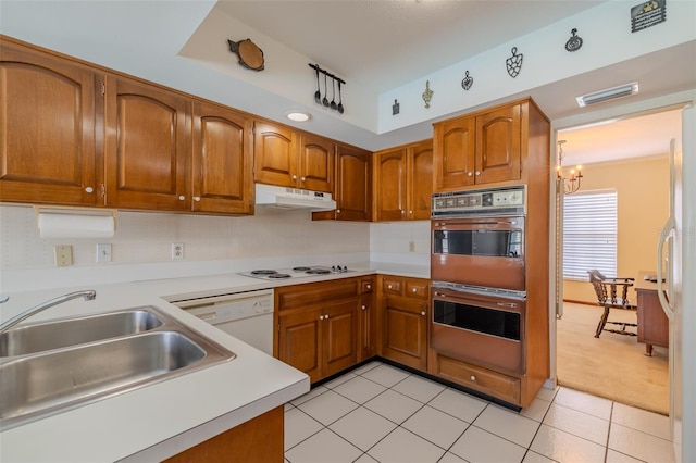 1302 Ivywood Dr, Brandon, FL 33510 - kitchen featuring white appliances, brown cabinets, a chandelier, and light countertops