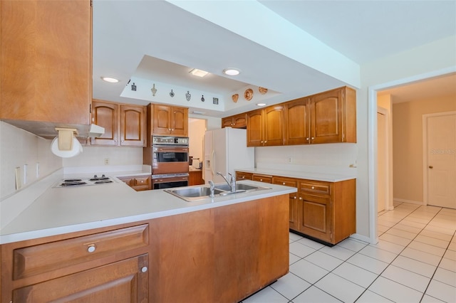 1302 Ivywood Dr, Brandon, FL 33510 - kitchen with white refrigerator with ice dispenser, electric cooktop, light countertops, light tile patterned floors, and a tray ceiling