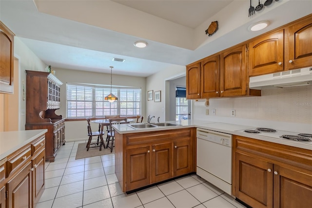 1302 Ivywood Dr, Brandon, FL 33510 - kitchen with white appliances, brown cabinetry, a peninsula, light countertops, and recessed lighting