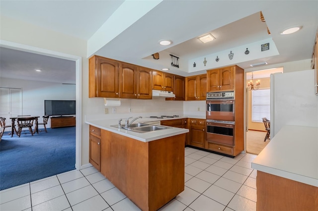 1302 Ivywood Dr, Brandon, FL 33510 - kitchen featuring white appliances, under cabinet range hood, a peninsula, brown cabinets, and light tile patterned floors