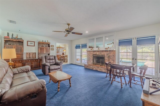 1302 Ivywood Dr, Brandon, FL 33510 - carpeted living area with a ceiling fan, french doors, and a fireplace