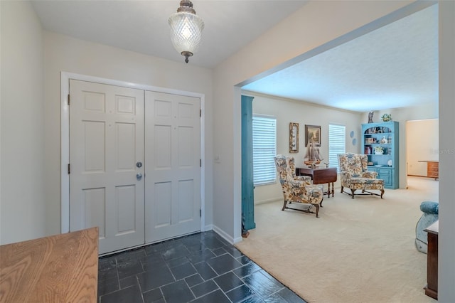 1302 Ivywood Dr, Brandon, FL 33510 - entryway with dark carpet and baseboards
