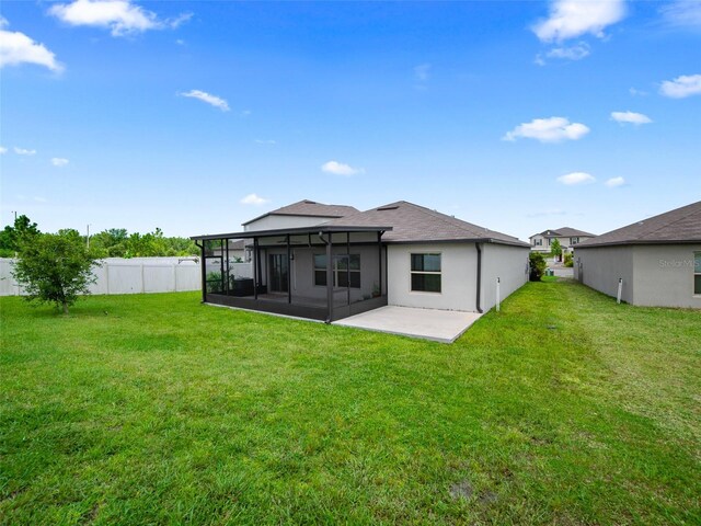 13646 Wild Ginger St, Riverview, FL 33579 - rear view of house with a sunroom, a patio, and a shingled roof